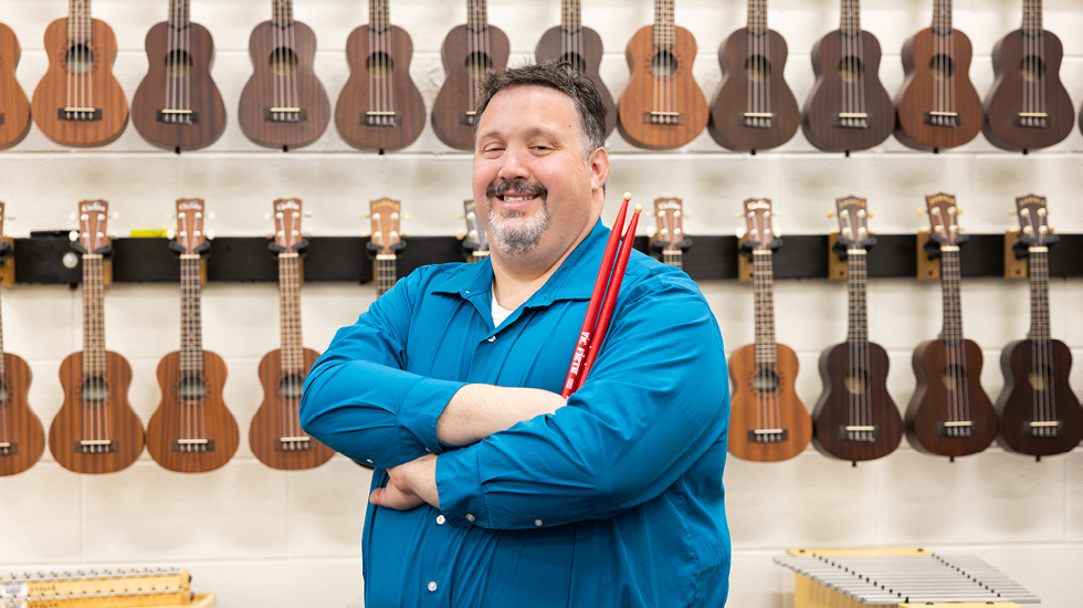 Regent University alum and elementary school music teacher Ernie Stokes, standing in his classroom in Virginia Beach, Virginia.