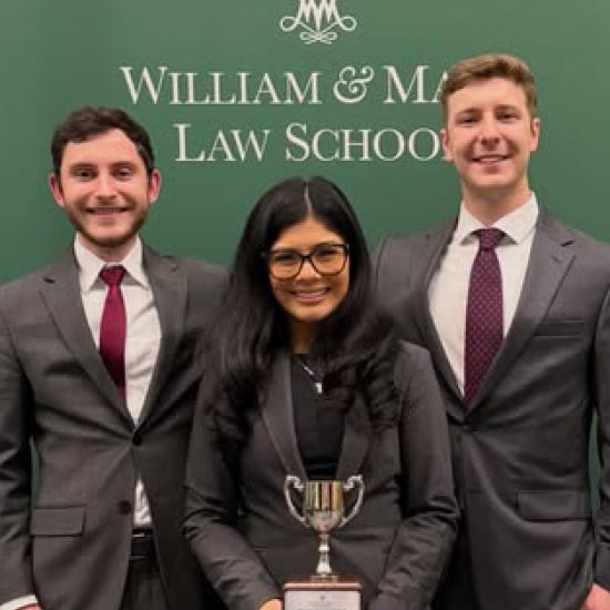 Regent Law Moot Court team Luke Puffer, Maxine Good, and Kellen Hasle standing as winners of the 55th Annual William B. Spong Jr. Moot Court Tournament.