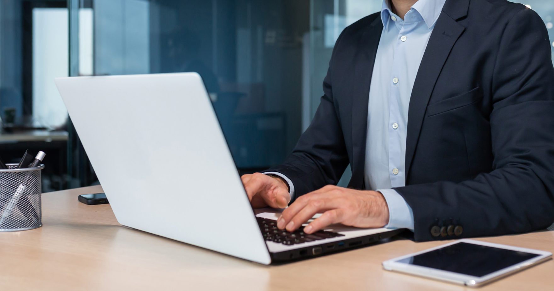 91���� law student typing on laptop on campus in Virginia Beach, Virginia.