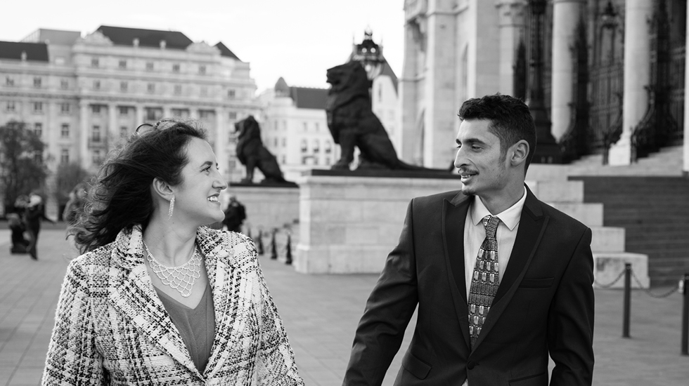 Regent University alumna Hannah Căldăraru smiles at her husband, Tavi, a Romanian native.