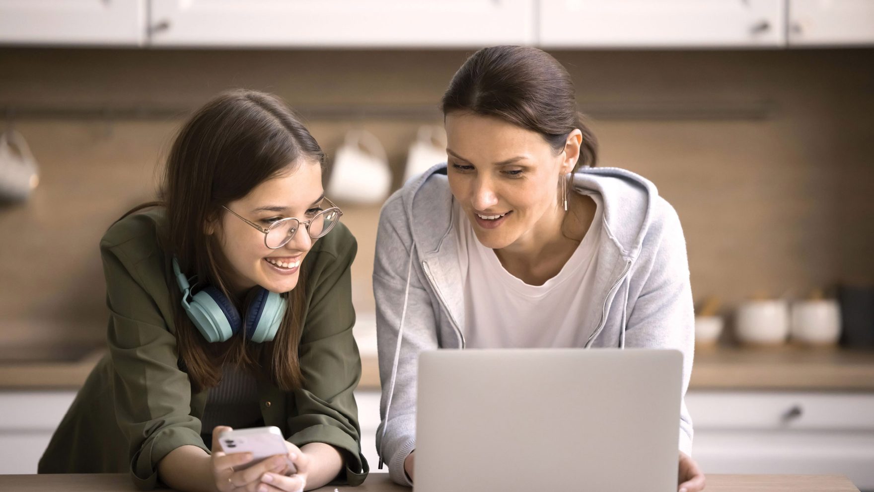 Mother and daughter looking at a computer together.