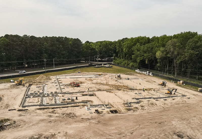 Aerial view of the construction site for Regent University's Athletic and Fitness Center showing foundation work underway