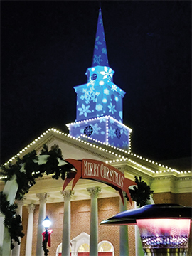 CBN Christmas Village at Regent University with illuminated chapel at night