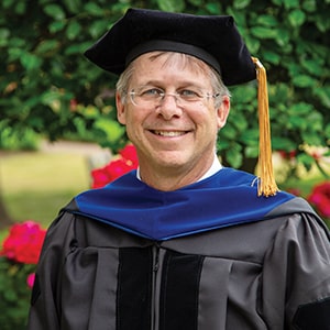 Dr. Chris Holdorf, Doctor of Strategic Leadership graduate, in academic regalia during Regent University commencement.