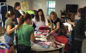 Regent students packing Operation Christmas Child shoeboxes with toys and supplies