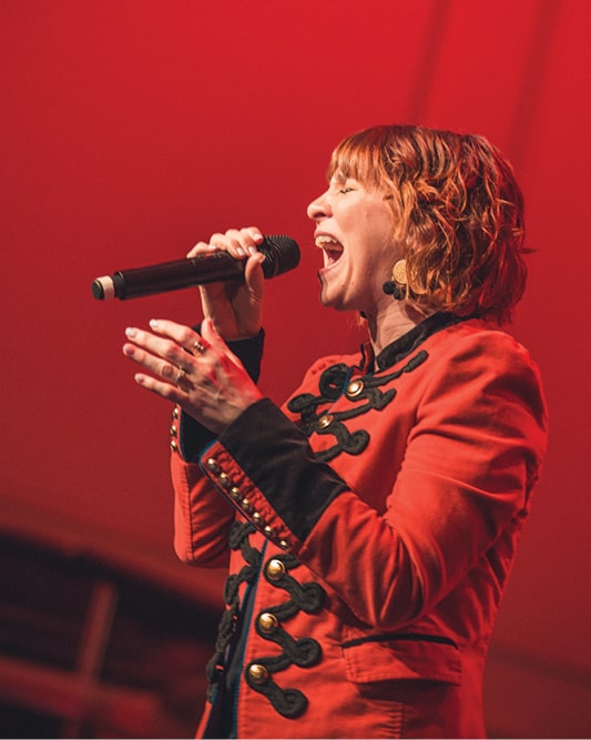 Kim Walker-Smith performing in red jacket at Regent University Night of Worship event