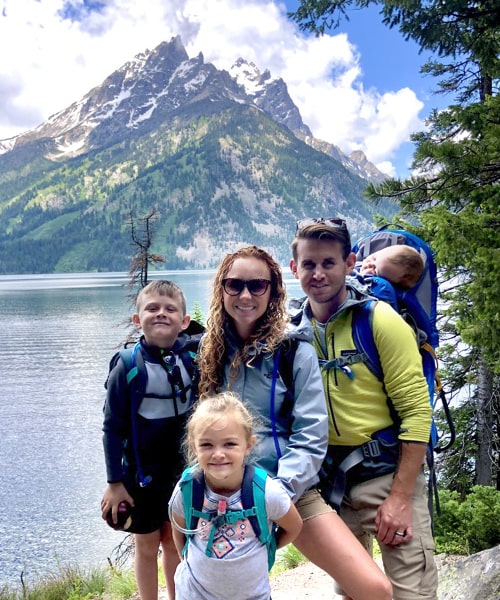 Courtney Brown with family hiking near mountain lake