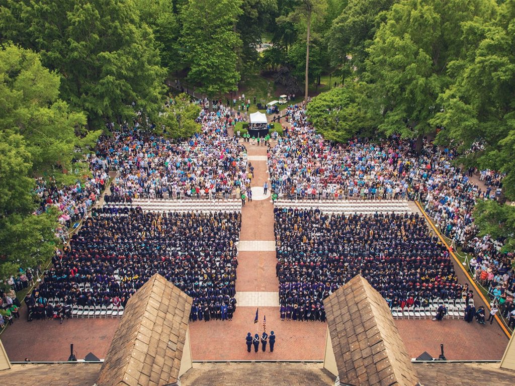 Aerial view of Regent University Commencement 2019 ceremony on Library Plaza with graduates and audience