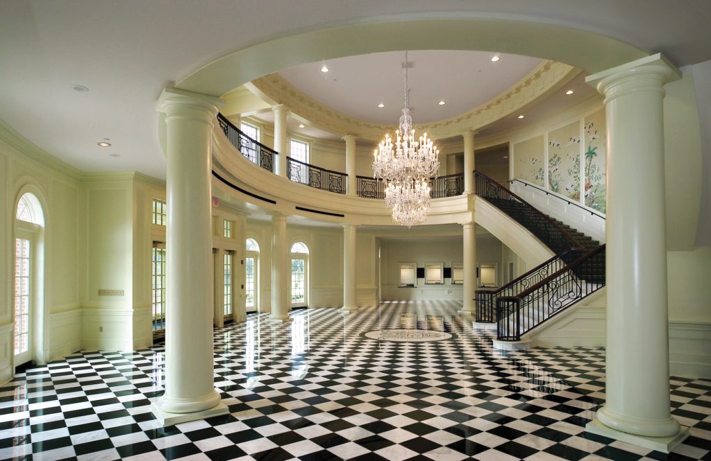 Dede Robertson Theatre lobby with chandelier, marble floor and grand staircase
