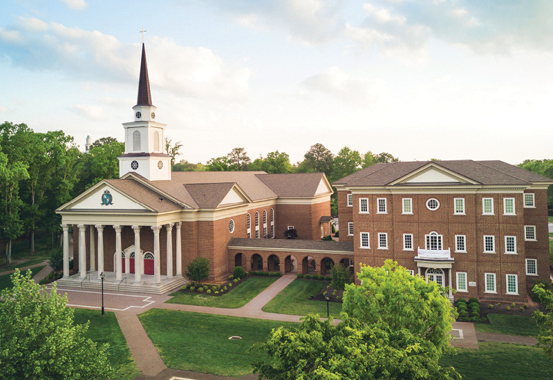 Aerial view of Regent University’s Chapel and Divinity Building surrounded by greenery on campus.