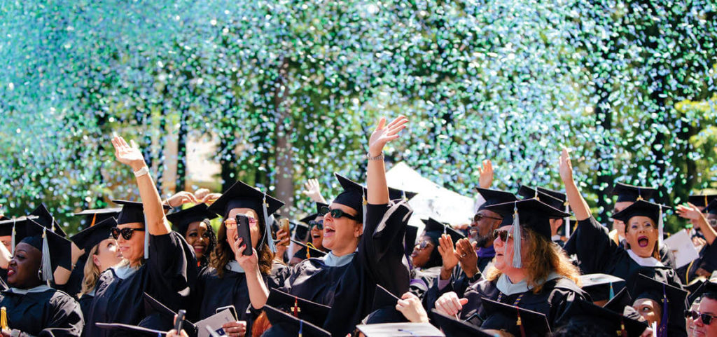 Graduates celebrating at Regent University's commencement ceremony in Virginia Beach.