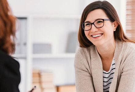 Counselor smiles while speaking with a client during a session at Regent University’s Psychological Services Center.