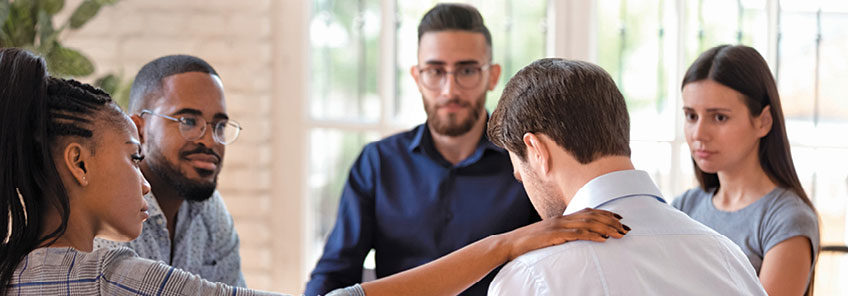 Group counseling session where participants offer prayer and support to one another, representing Regent’s commitment to holistic mental health care.