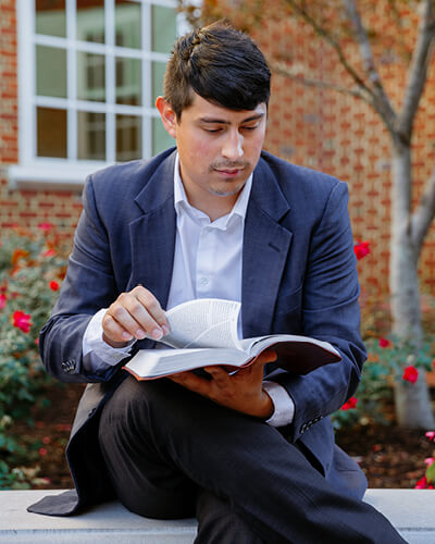An alumnus read at Regent University's prayer garden in Virginia Beach, VA 23464.