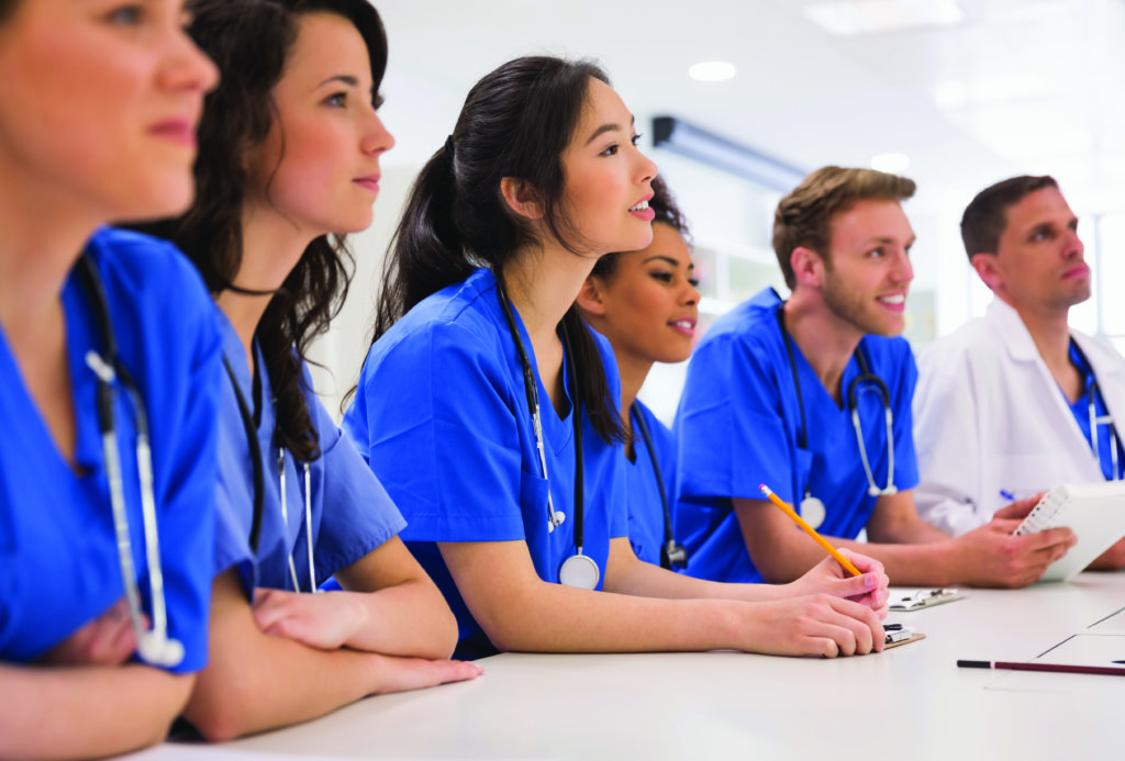 Nursing students in blue scrubs attending class at Regent University